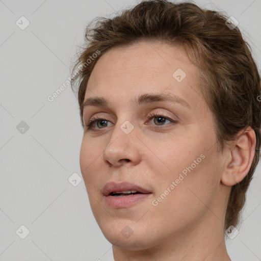 Joyful white adult female with medium  brown hair and grey eyes