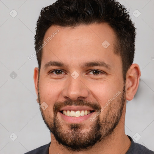 Joyful white young-adult male with short  brown hair and brown eyes