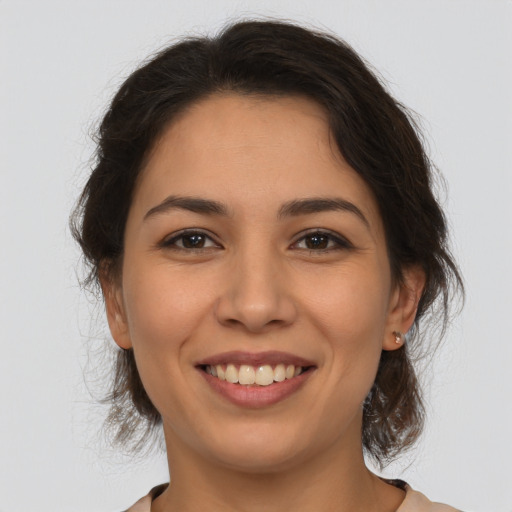 Joyful white young-adult female with medium  brown hair and brown eyes