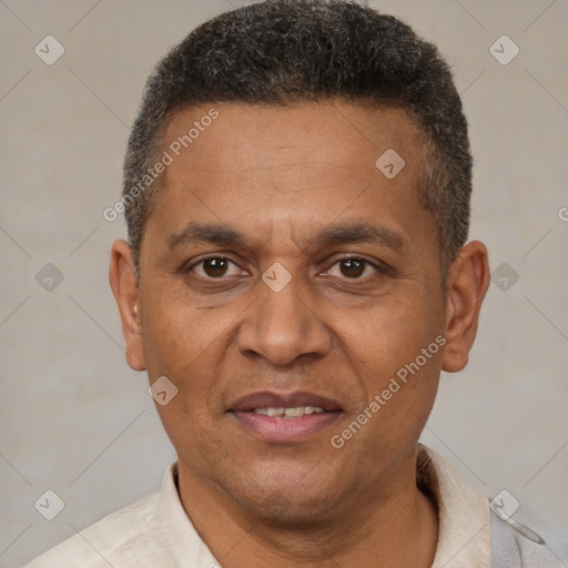 Joyful black adult male with short  brown hair and brown eyes