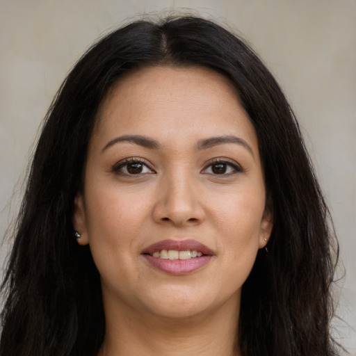 Joyful latino young-adult female with long  brown hair and brown eyes