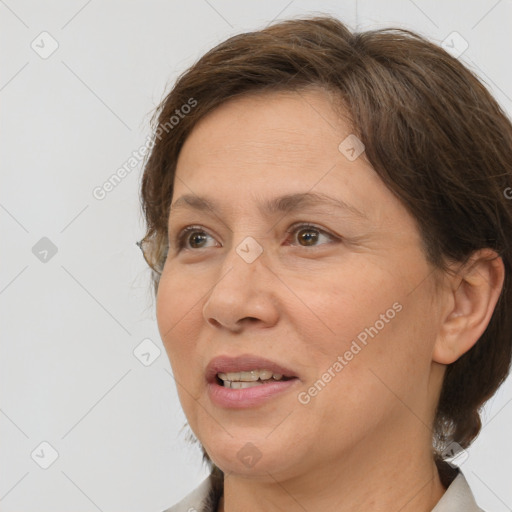 Joyful white adult female with medium  brown hair and brown eyes