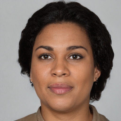 Joyful latino young-adult female with short  brown hair and brown eyes