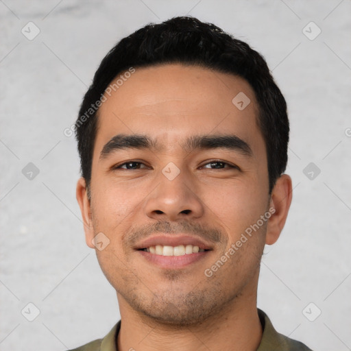 Joyful latino young-adult male with short  black hair and brown eyes