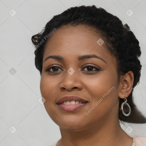 Joyful black young-adult female with long  black hair and brown eyes