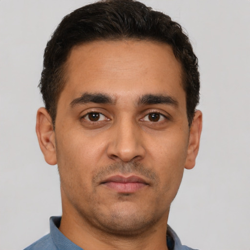 Neutral latino young-adult male with short  black hair and brown eyes