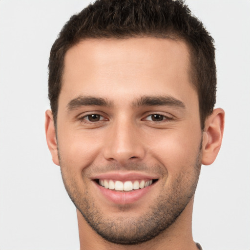 Joyful white young-adult male with short  brown hair and brown eyes