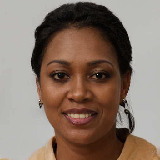 Joyful black adult female with short  black hair and brown eyes