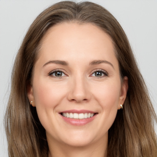 Joyful white young-adult female with long  brown hair and brown eyes