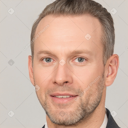 Joyful white adult male with short  brown hair and brown eyes