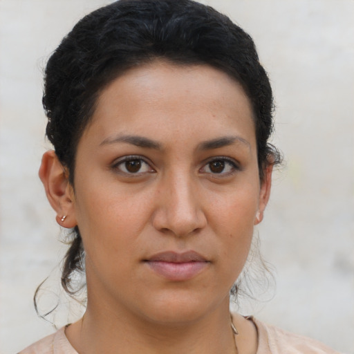 Joyful latino young-adult female with short  brown hair and brown eyes