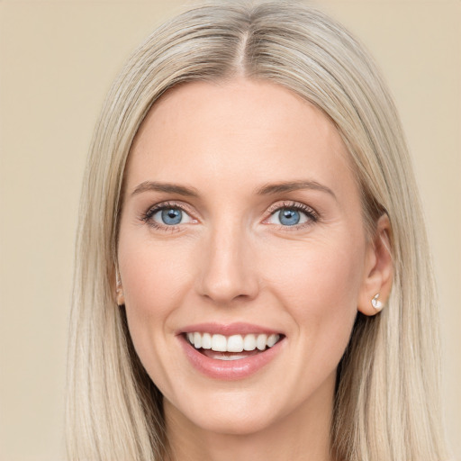 Joyful white young-adult female with long  brown hair and blue eyes