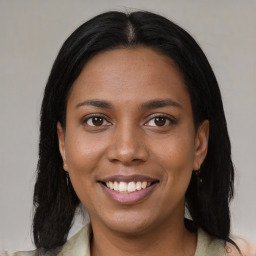 Joyful black young-adult female with medium  brown hair and brown eyes