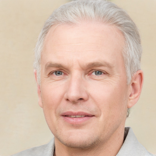 Joyful white adult male with short  gray hair and brown eyes