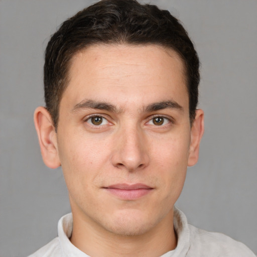 Joyful white young-adult male with short  brown hair and brown eyes