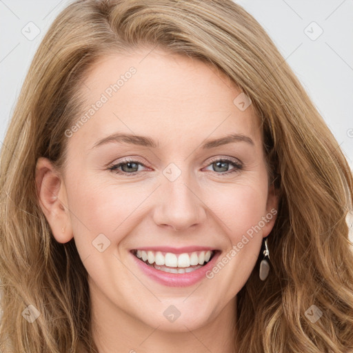 Joyful white young-adult female with long  brown hair and blue eyes