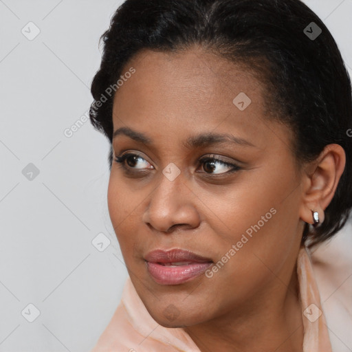 Joyful black young-adult female with short  brown hair and brown eyes