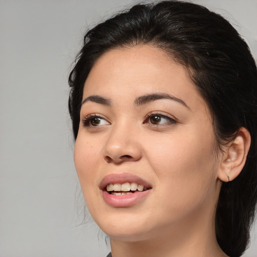 Joyful asian young-adult female with long  black hair and brown eyes