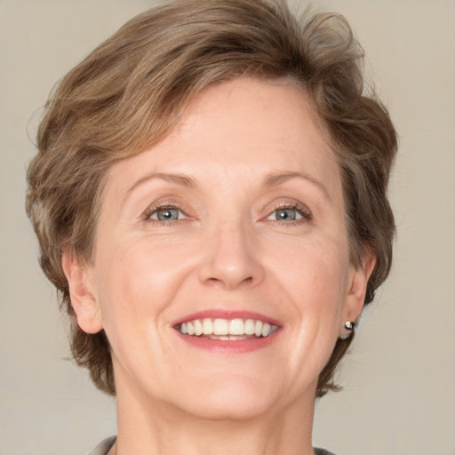 Joyful white adult female with medium  brown hair and grey eyes