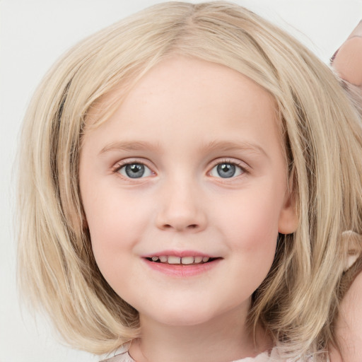 Joyful white child female with medium  brown hair and blue eyes