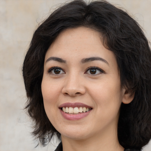 Joyful asian young-adult female with long  brown hair and brown eyes