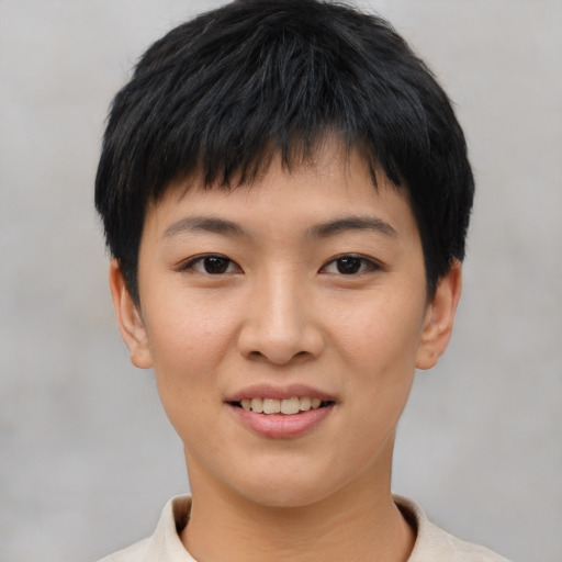 Joyful asian young-adult female with short  black hair and brown eyes