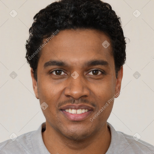 Joyful black young-adult male with short  black hair and brown eyes