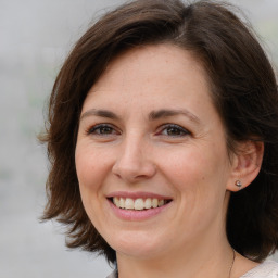 Joyful white adult female with medium  brown hair and brown eyes