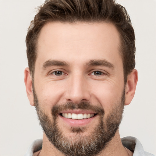 Joyful white young-adult male with short  brown hair and brown eyes