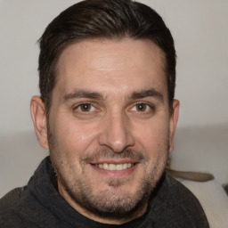 Joyful white adult male with short  brown hair and brown eyes