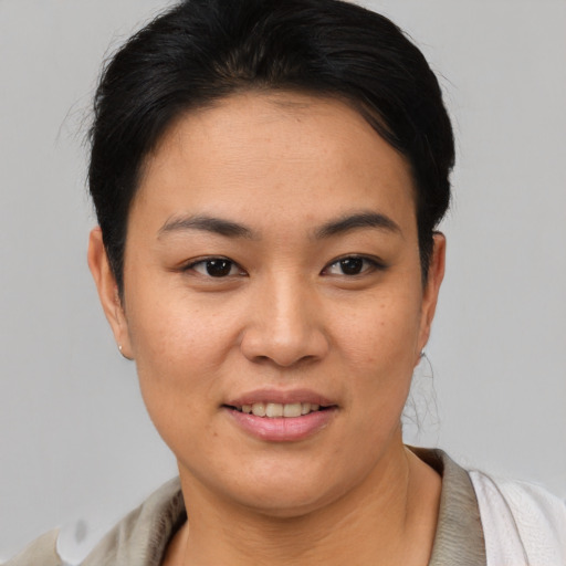 Joyful asian young-adult female with short  brown hair and brown eyes