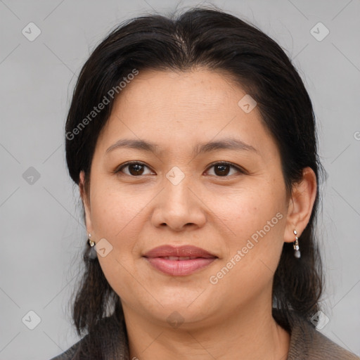 Joyful asian adult female with medium  brown hair and brown eyes