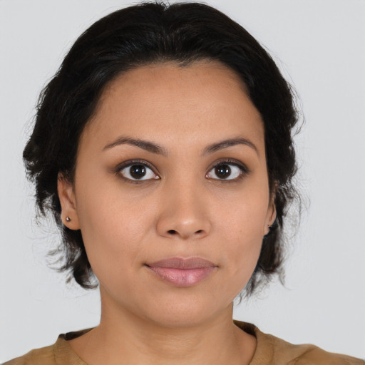 Joyful latino young-adult female with medium  brown hair and brown eyes