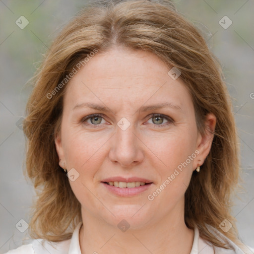 Joyful white adult female with medium  brown hair and blue eyes