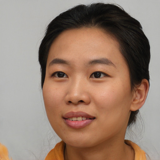 Joyful asian young-adult female with medium  brown hair and brown eyes