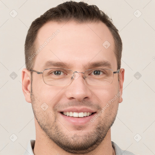 Joyful white young-adult male with short  brown hair and grey eyes