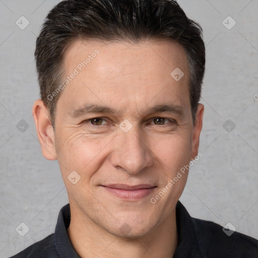 Joyful white adult male with short  brown hair and brown eyes