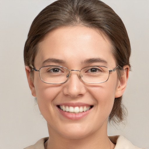 Joyful white adult female with medium  brown hair and grey eyes