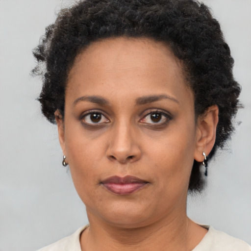 Neutral black adult female with short  brown hair and brown eyes