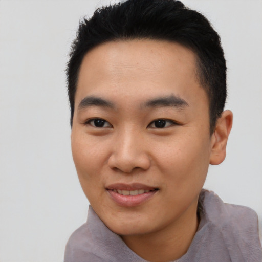 Joyful asian young-adult male with short  black hair and brown eyes