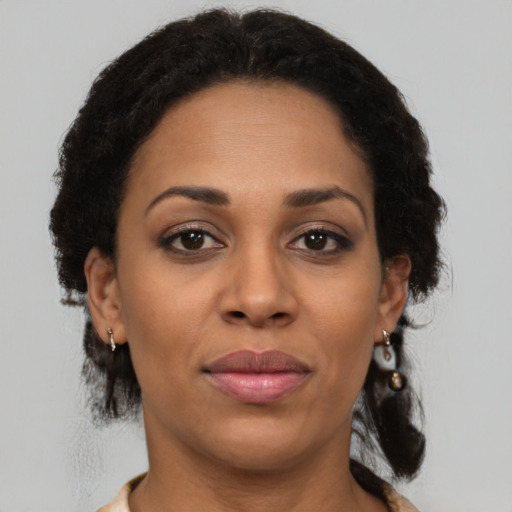 Joyful latino adult female with short  brown hair and brown eyes