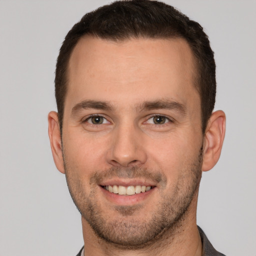 Joyful white young-adult male with short  brown hair and brown eyes