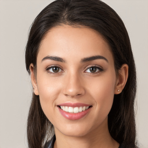 Joyful white young-adult female with long  brown hair and brown eyes