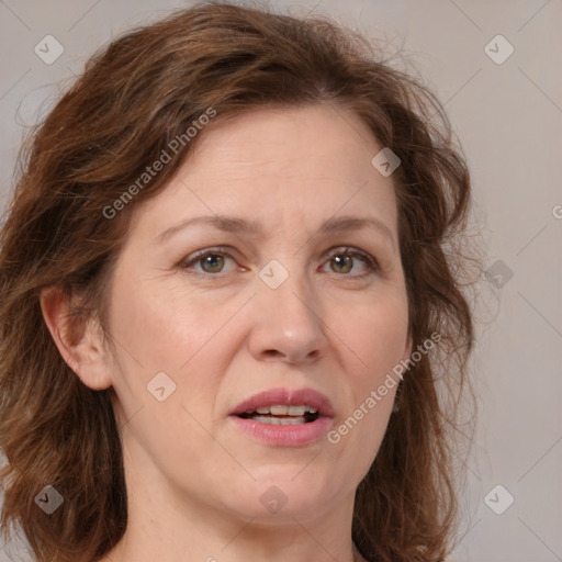 Joyful white adult female with medium  brown hair and green eyes