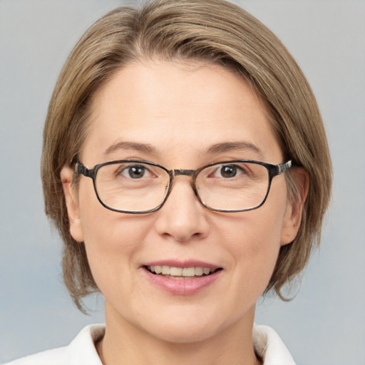 Joyful white adult female with medium  brown hair and grey eyes