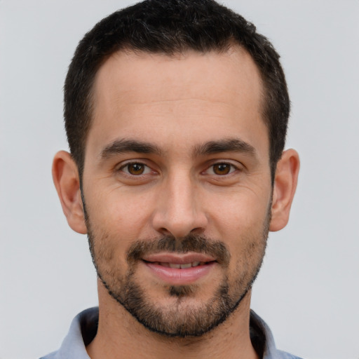 Joyful white young-adult male with short  brown hair and brown eyes