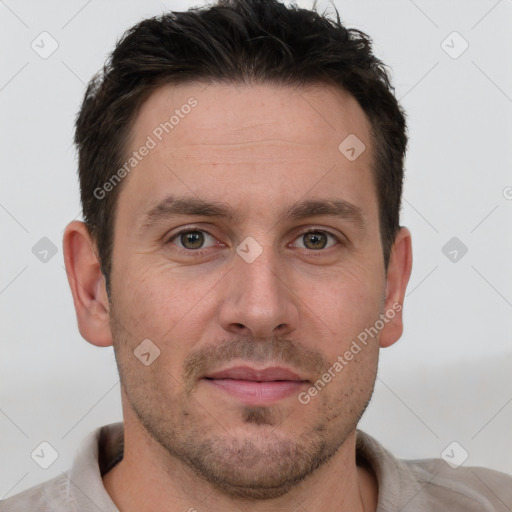 Joyful white adult male with short  brown hair and grey eyes