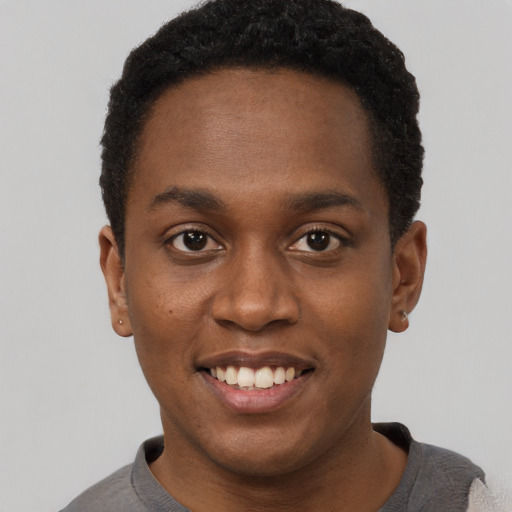 Joyful black young-adult male with short  brown hair and brown eyes