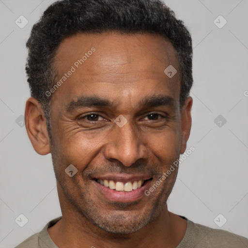 Joyful black adult male with short  black hair and brown eyes