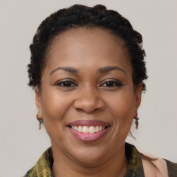 Joyful black adult female with medium  brown hair and brown eyes